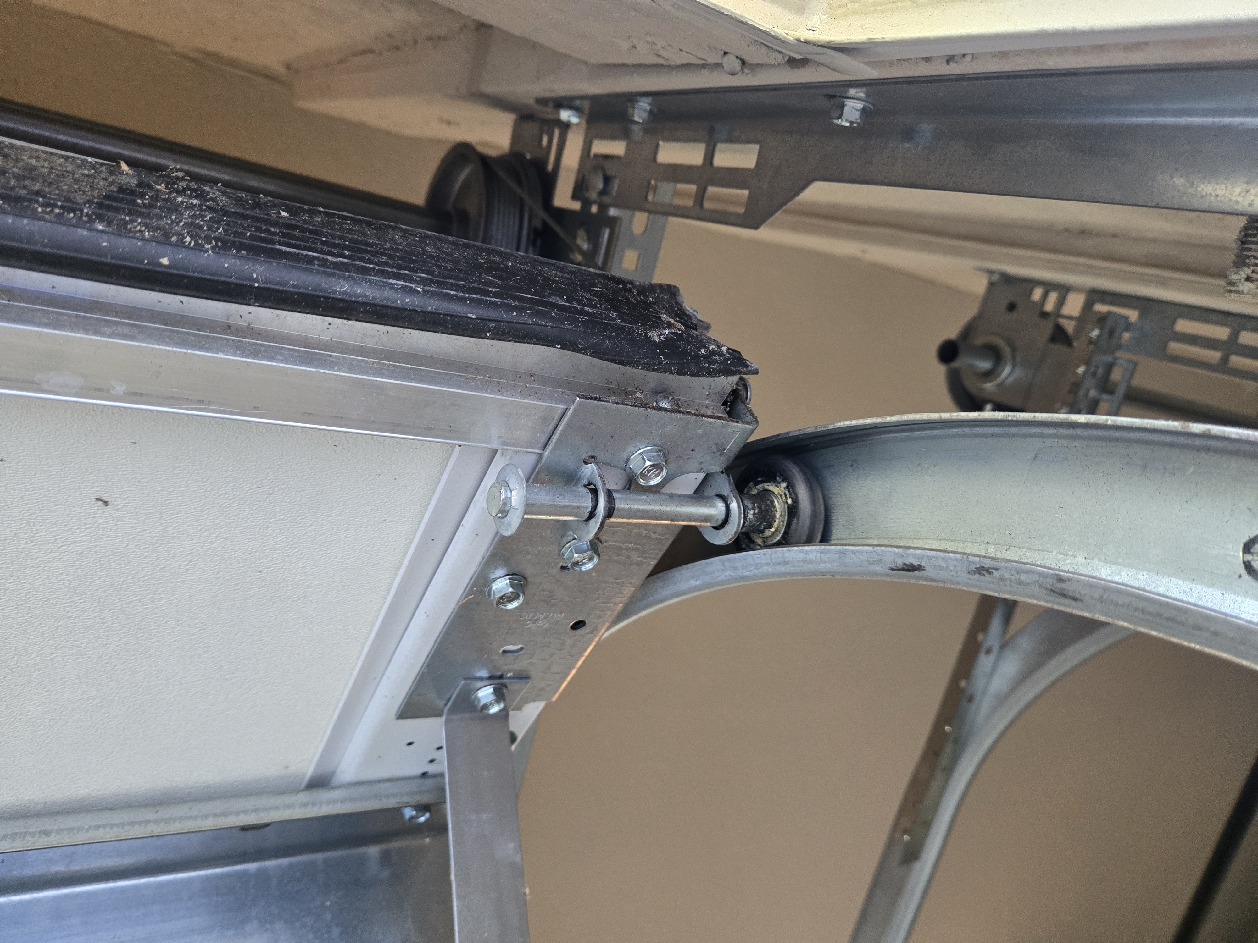 Worn garage door roller before service