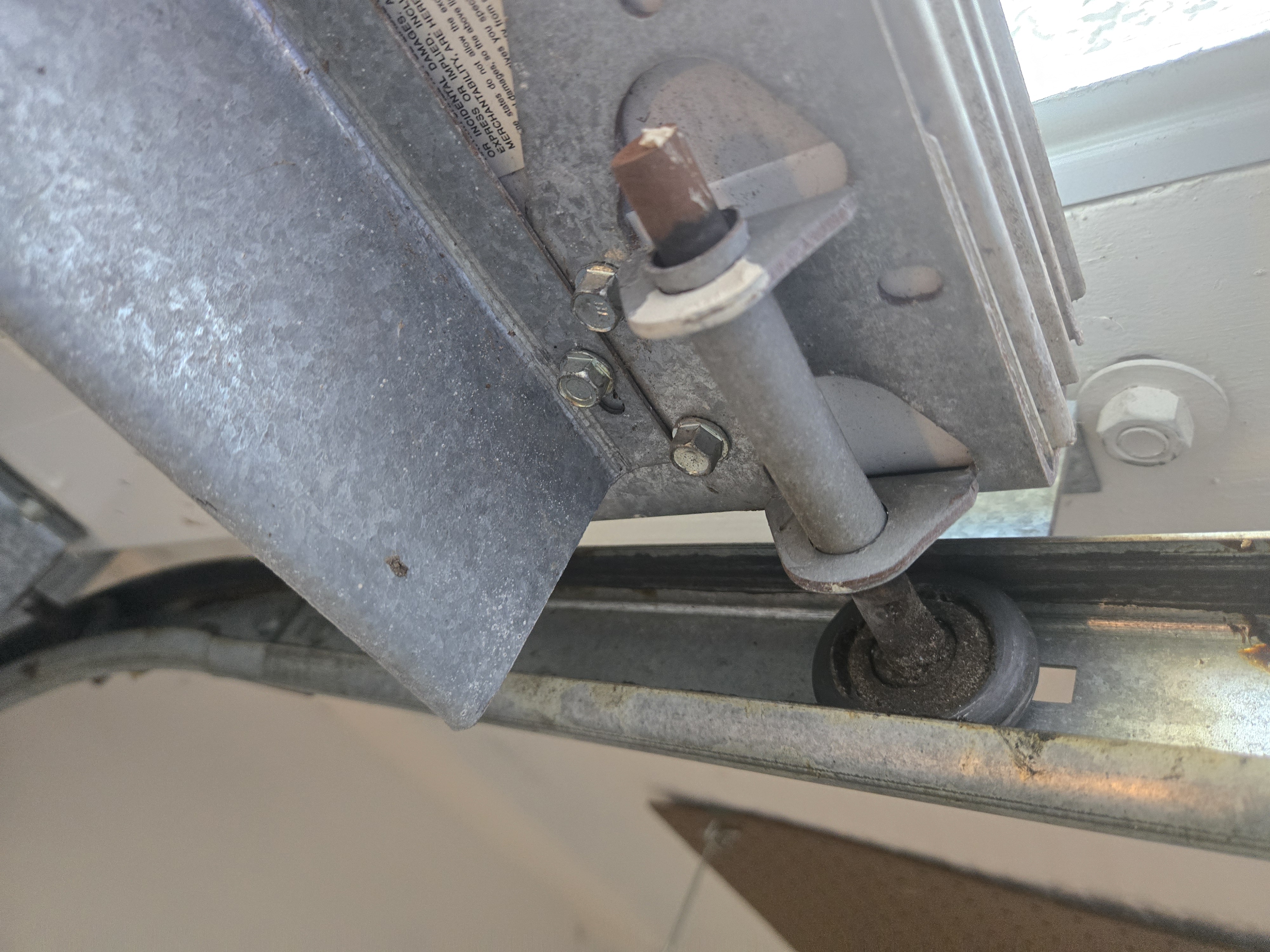 Damaged garage door roller before replacement