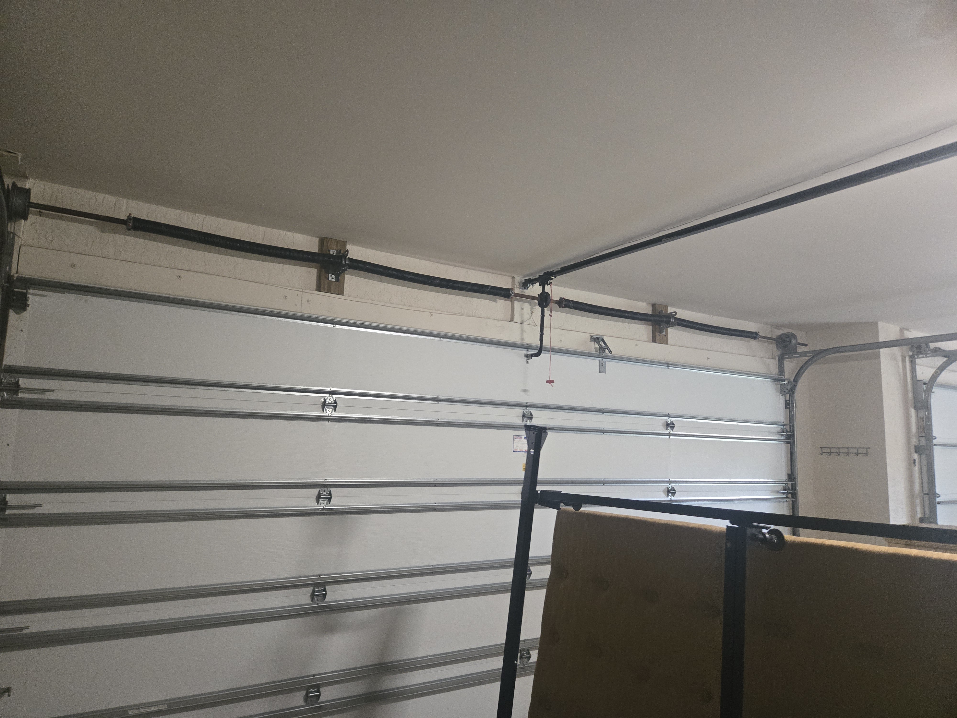 Newly installed garage door spring after replacement