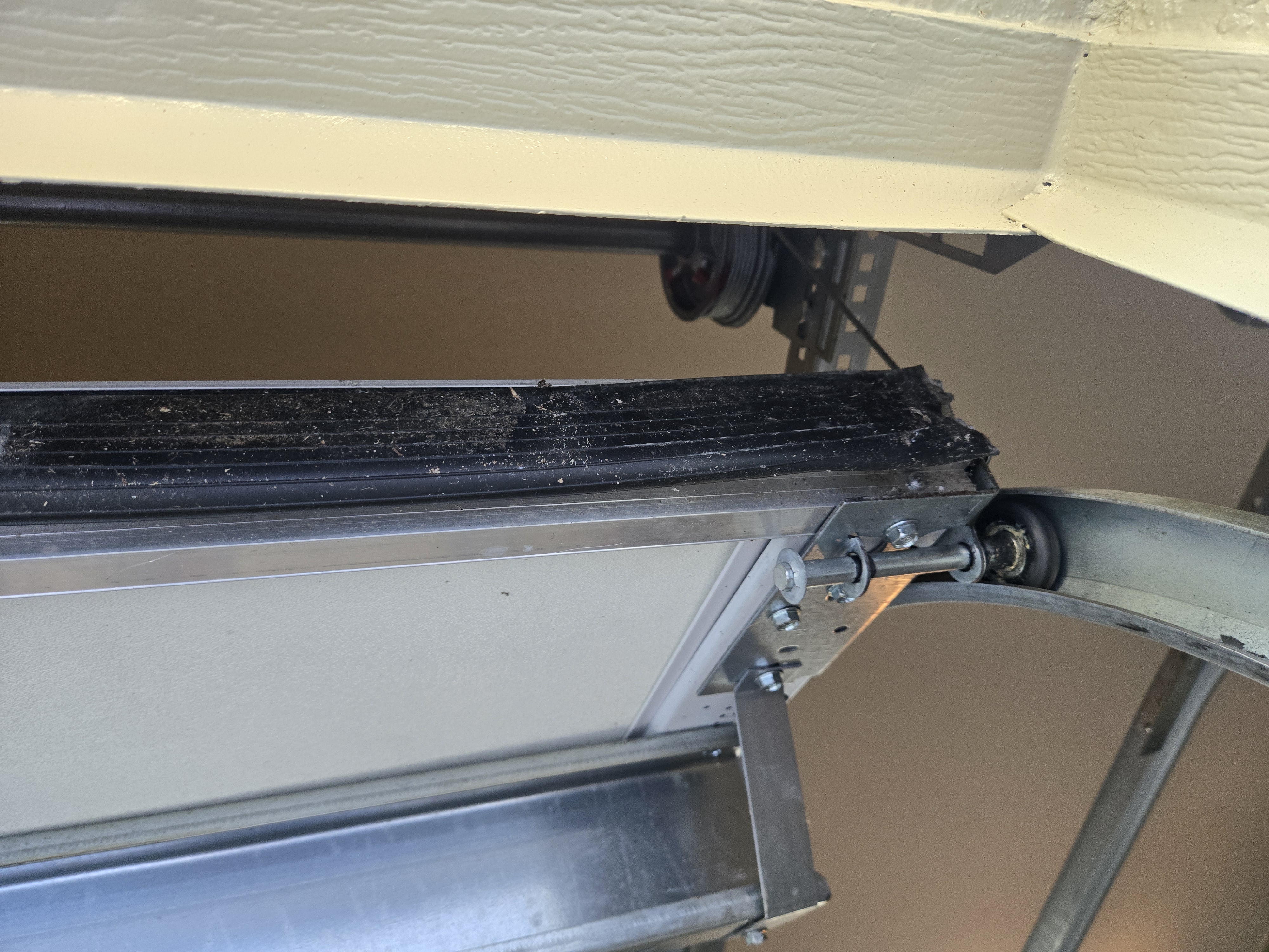 Worn and cracked garage door bottom seal before replacement